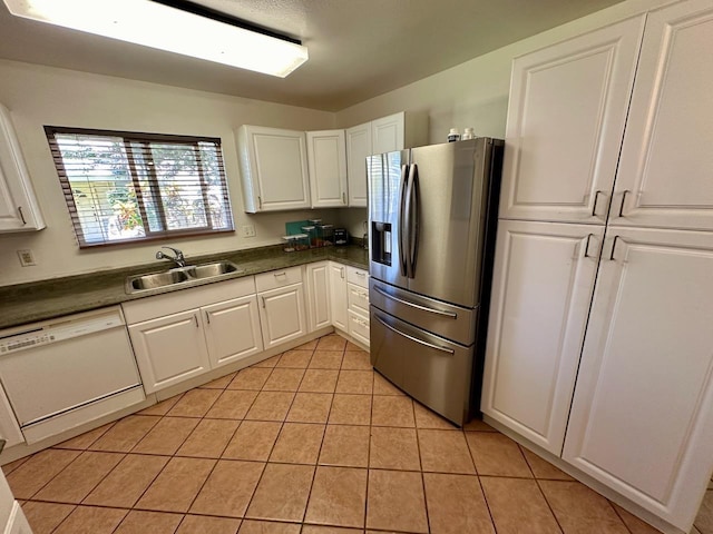 kitchen featuring white cabinetry, stainless steel refrigerator with ice dispenser, sink, white dishwasher, and light tile patterned floors