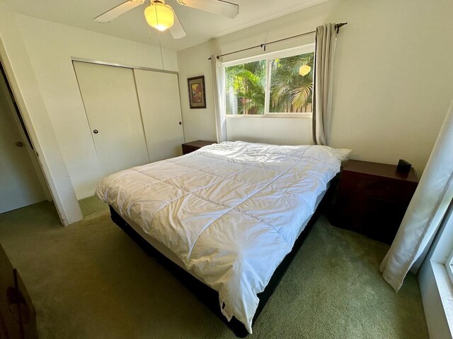 bedroom featuring carpet floors, ceiling fan, and a closet