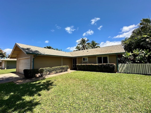 single story home with a garage and a front lawn