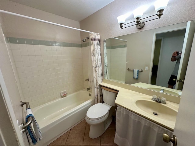 full bathroom featuring shower / bath combo with shower curtain, tile patterned flooring, a textured ceiling, toilet, and vanity