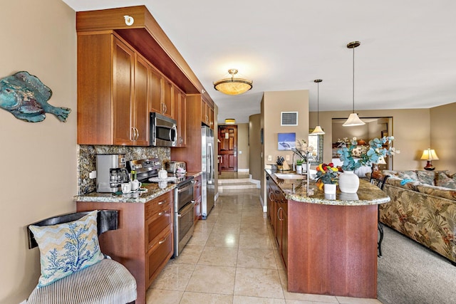 50 Nohea Kai Dr Unit 2-702, Lahaina, HI 96761 - kitchen with appliances with stainless steel finishes, open floor plan, light stone countertops, decorative backsplash, and brown cabinets
