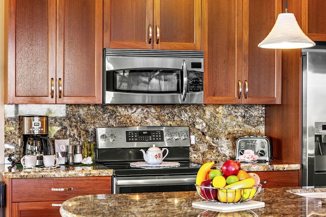 50 Nohea Kai Dr Unit 2-702, Lahaina, HI 96761 - kitchen featuring stainless steel appliances, backsplash, dark stone counters, and brown cabinets