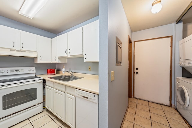 kitchen with stacked washer / dryer, white cabinetry, sink, and white appliances