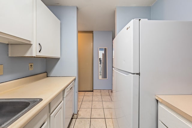 kitchen with white cabinetry, light tile patterned flooring, white appliances, and sink