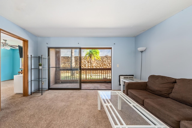 carpeted living room with ceiling fan