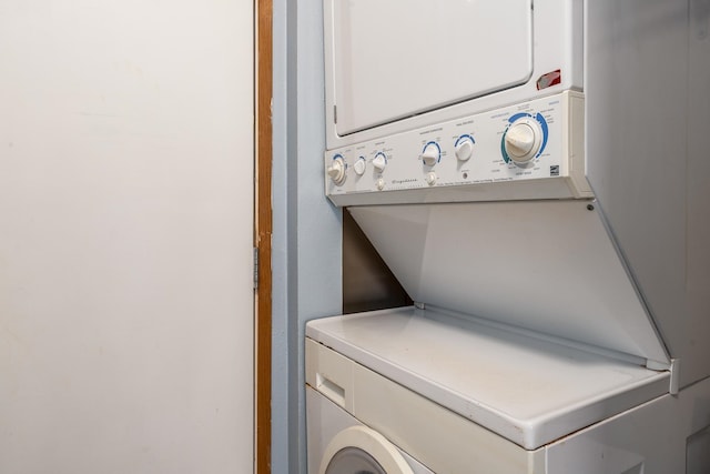 clothes washing area featuring stacked washer and dryer