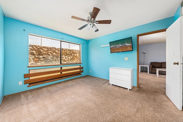 unfurnished bedroom with ceiling fan and light colored carpet