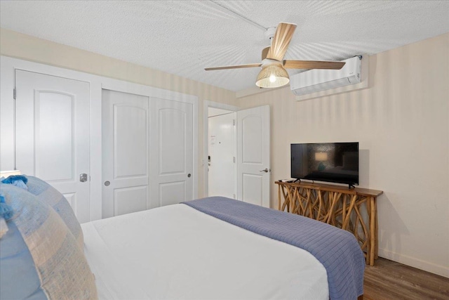 bedroom with wood finished floors, baseboards, a closet, ceiling fan, and a textured ceiling