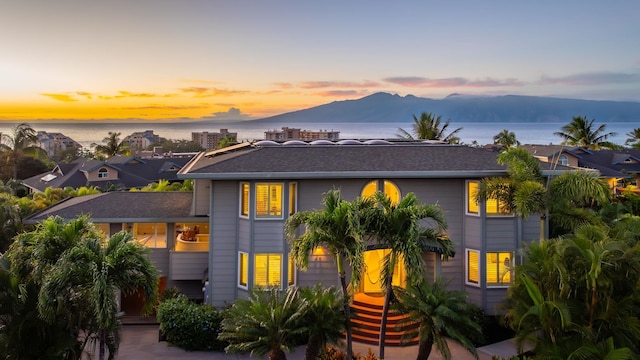 view of front of property with a water and mountain view