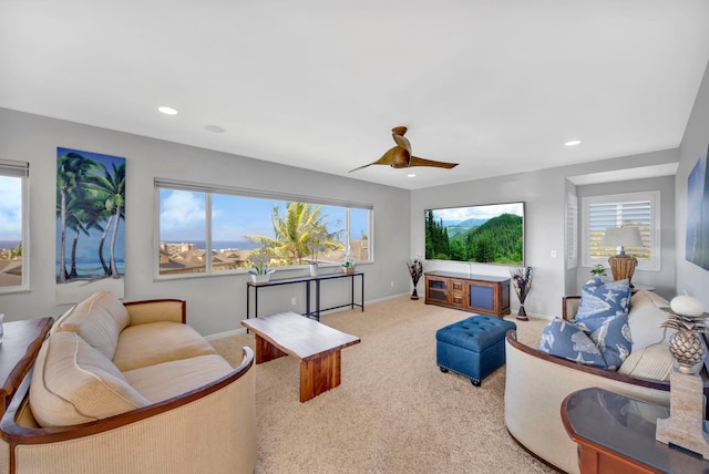 living room with ceiling fan and carpet floors