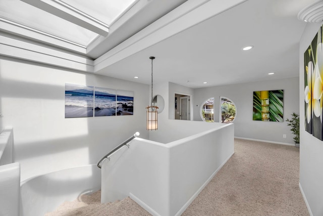 hallway with light colored carpet