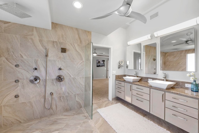 bathroom featuring tiled shower and vanity