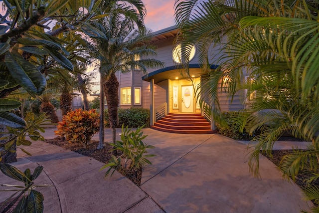 view of exterior entry at dusk