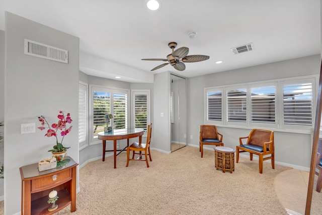 home office with ceiling fan and light colored carpet