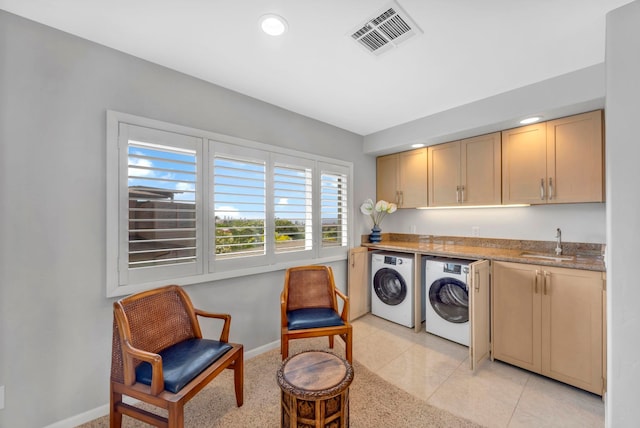 laundry area featuring cabinets, sink, light tile patterned floors, and independent washer and dryer