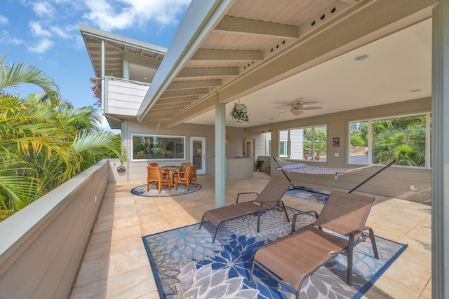 view of patio / terrace with ceiling fan and a balcony