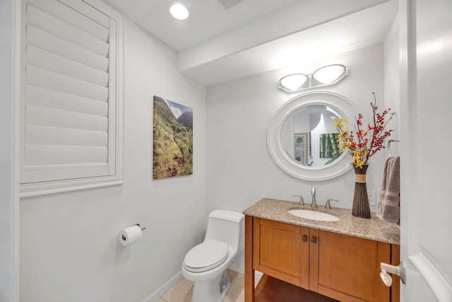 bathroom featuring toilet, tile patterned flooring, and vanity