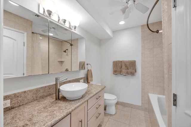 full bathroom with vanity, toilet, tiled shower / bath, and tile patterned flooring