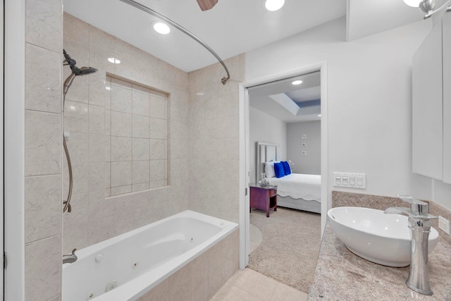 bathroom featuring sink, tile patterned floors, and tiled shower / bath combo