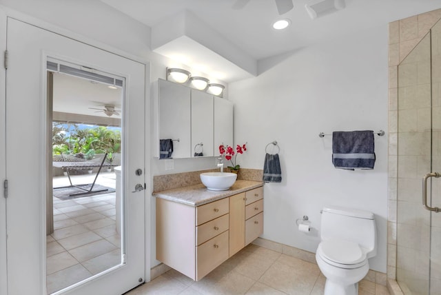 bathroom featuring tile patterned floors, vanity, toilet, walk in shower, and ceiling fan