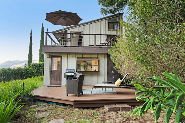 rear view of house with a balcony and a deck