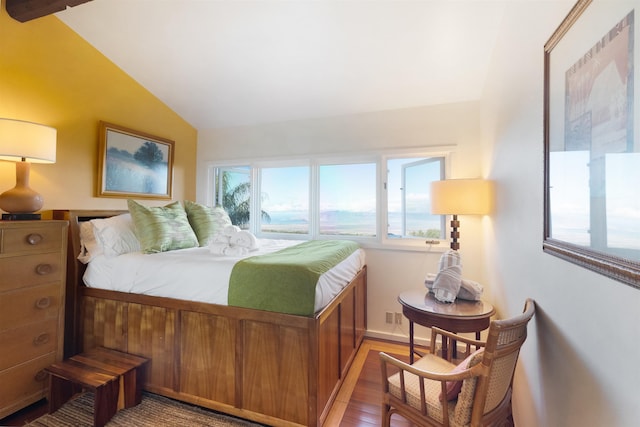 bedroom with vaulted ceiling and hardwood / wood-style flooring