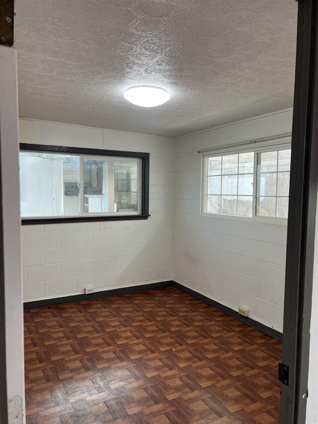 737 Kolani Pl, Wailuku, HI 96793 - empty room featuring concrete block wall and a textured ceiling