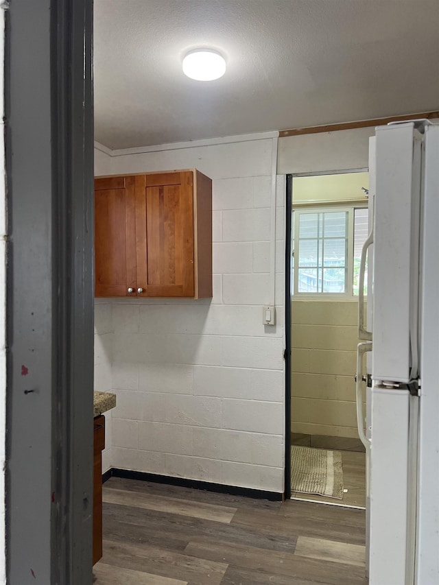 737 Kolani Pl, Wailuku, HI 96793 - interior space featuring concrete block wall and dark wood-style floors