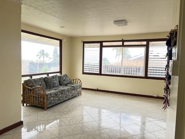 737 Kolani Pl, Wailuku, HI 96793 - living area featuring baseboards, a textured ceiling, and light tile patterned flooring