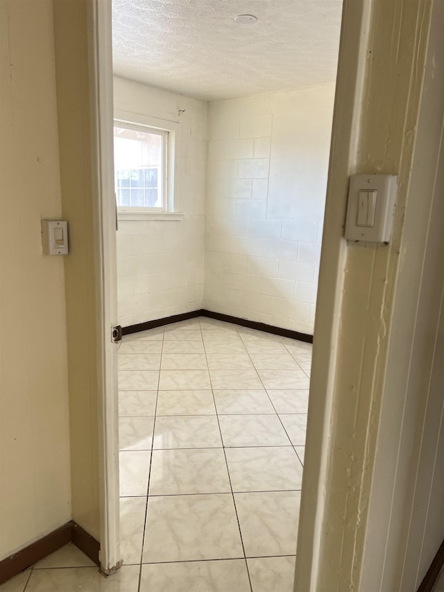 737 Kolani Pl, Wailuku, HI 96793 - unfurnished room with baseboards, a textured ceiling, and light tile patterned floors