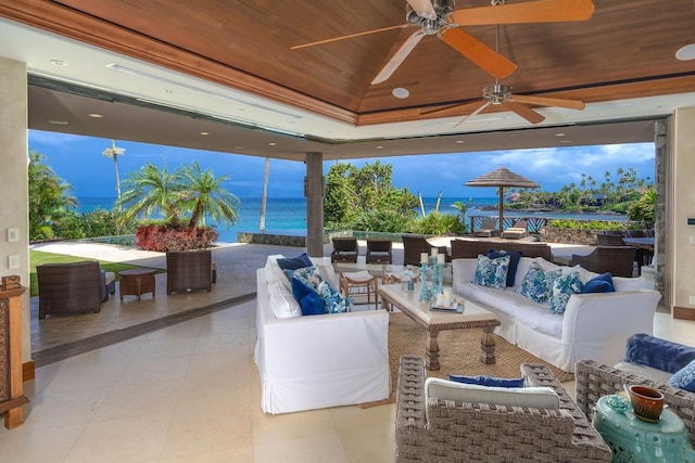 view of patio featuring an outdoor living space, a water view, and ceiling fan