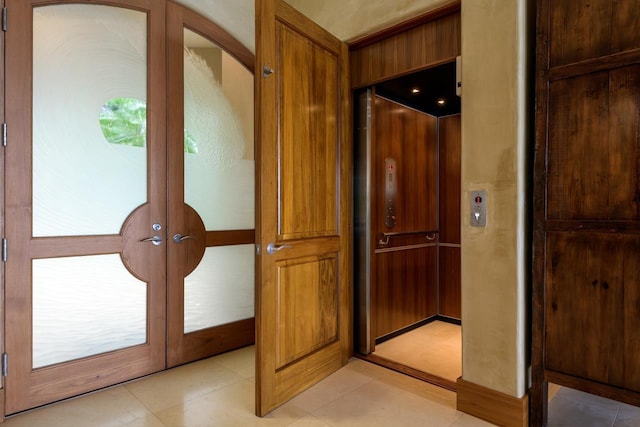 doorway to outside with wood walls, a wealth of natural light, and french doors