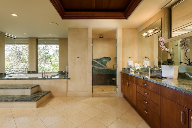 bathroom featuring a raised ceiling, tile patterned flooring, separate shower and tub, crown molding, and vanity