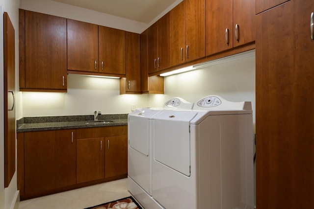 laundry room with cabinets, sink, and washer and dryer