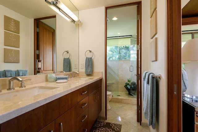 bathroom with tile patterned flooring, vanity, toilet, and an enclosed shower