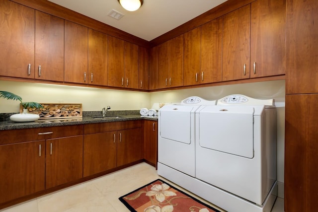 washroom featuring washer and dryer, cabinets, and sink