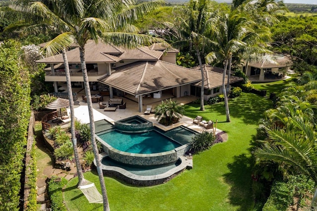 view of swimming pool with a lawn, an outdoor living space, a patio area, and an in ground hot tub