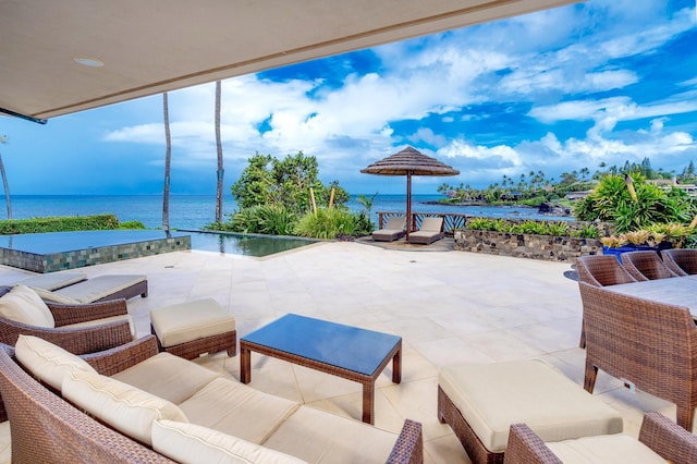 view of patio with an outdoor living space and a water view