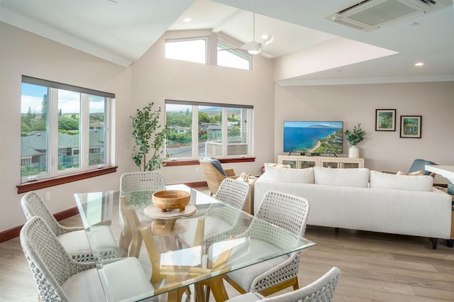 dining area featuring lofted ceiling and light wood-type flooring