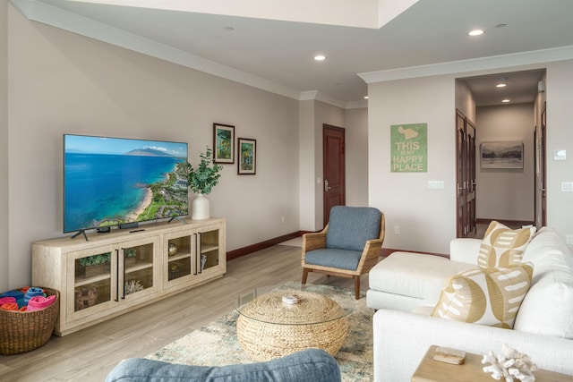 living room with light wood-type flooring and ornamental molding