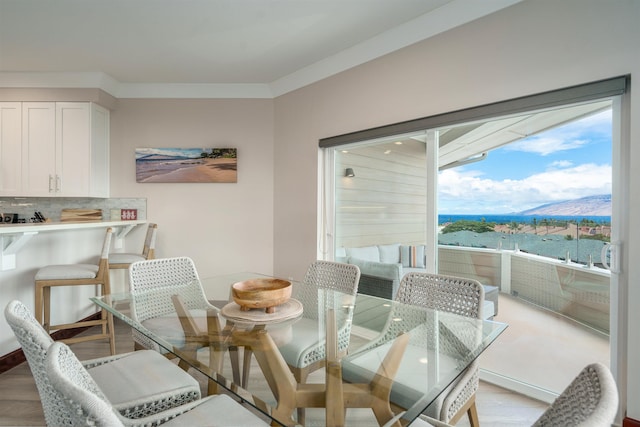 dining area featuring a water and mountain view