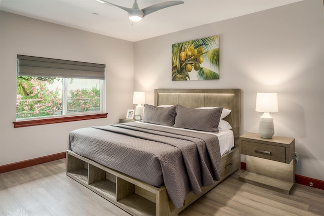 bedroom with ceiling fan and light hardwood / wood-style floors