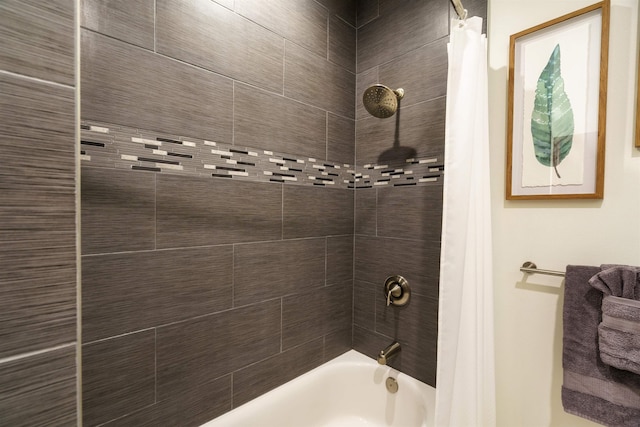 bathroom with shower / bath combo with shower curtain