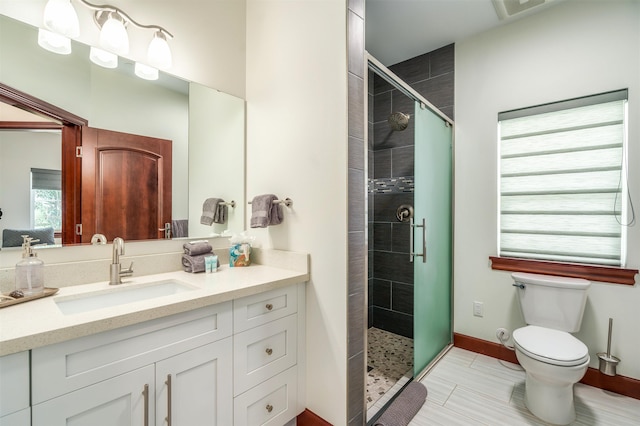 bathroom featuring walk in shower, vanity, and toilet