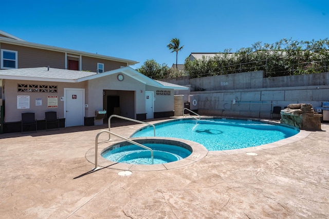 view of pool featuring a community hot tub and a patio