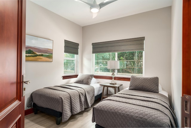 bedroom with ceiling fan and light wood-type flooring