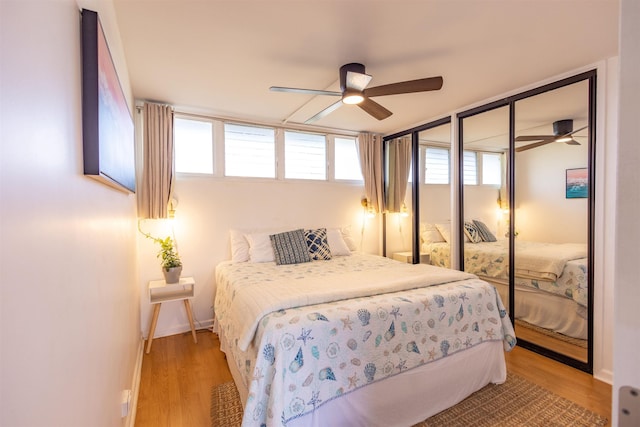 3823 Lower Honoapiilani Rd Unit 302, Lahaina, HI 96761 - bedroom featuring multiple windows, light wood-style flooring, and baseboards