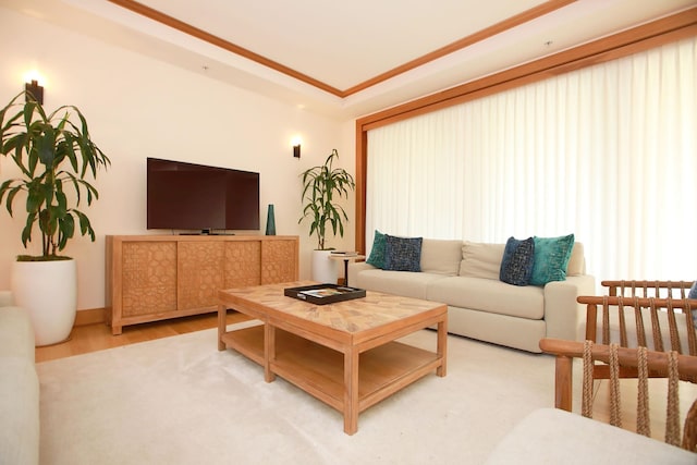 living room featuring hardwood / wood-style floors and crown molding