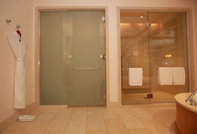 bathroom with tile floors and walk in shower