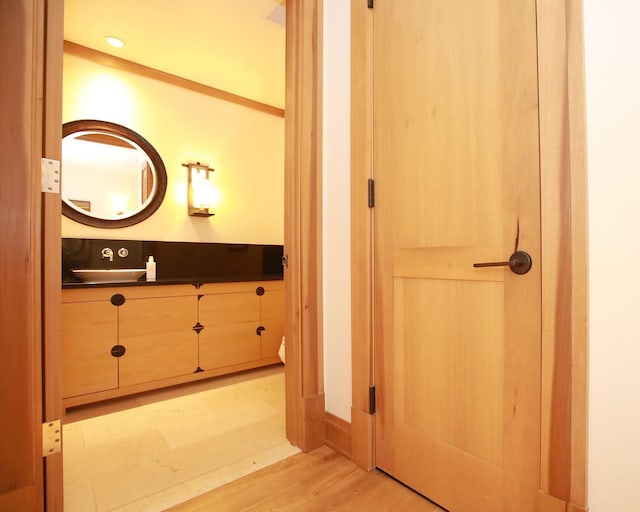 bathroom featuring hardwood / wood-style flooring and vanity